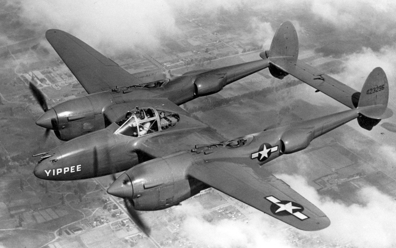 Fresh from the factory, P-38J Yippee, the 5,000th Lightning delivered to the US Army Air Forces, flies over California in 1944. This aircraft was shipped to the Pacific Theater but was subsequently lost in an accident in the Philippines in 1945. (US Air Force)